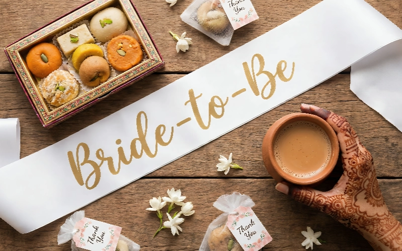 Bride-to-be sash with sweets and tea setup, perfect for bridal shower gifts and pre-wedding celebration ideas