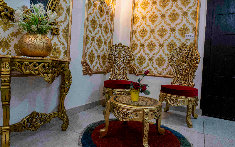 Luxury seating area in Islamabad guest house with ornate chairs and decor, perfect for brand photoshoots and premium stays