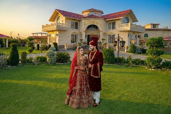 Couple in wedding attire posing at a luxury farmhouse in Islamabad, perfect outdoor photoshoot venue with private scenic surroundings